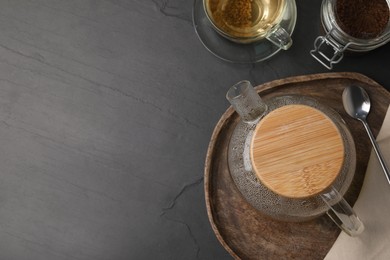 Photo of Freshly made buckwheat tea served on grey table, flat lay. Space for text