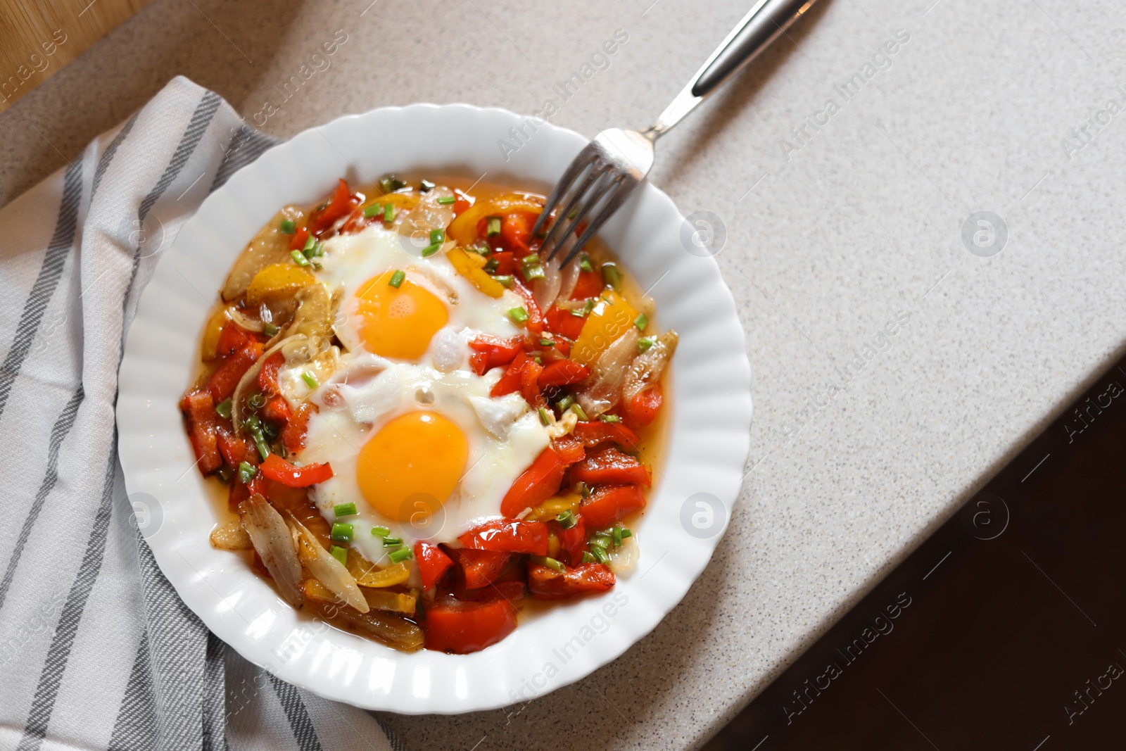 Photo of Plate of tasty fried eggs with vegetables on table, flat lay. Space for text