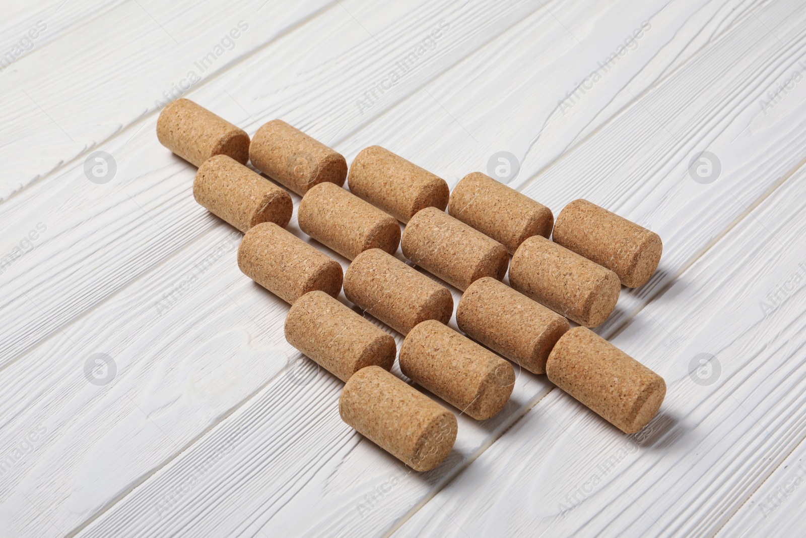 Photo of Christmas tree made of wine corks on white wooden table