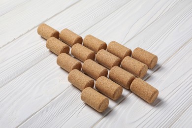 Photo of Christmas tree made of wine corks on white wooden table