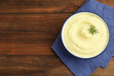 Photo of Freshly cooked homemade mashed potatoes on wooden table, top view. Space for text