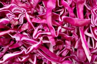 Photo of Tasty fresh shredded red cabbage as background, closeup