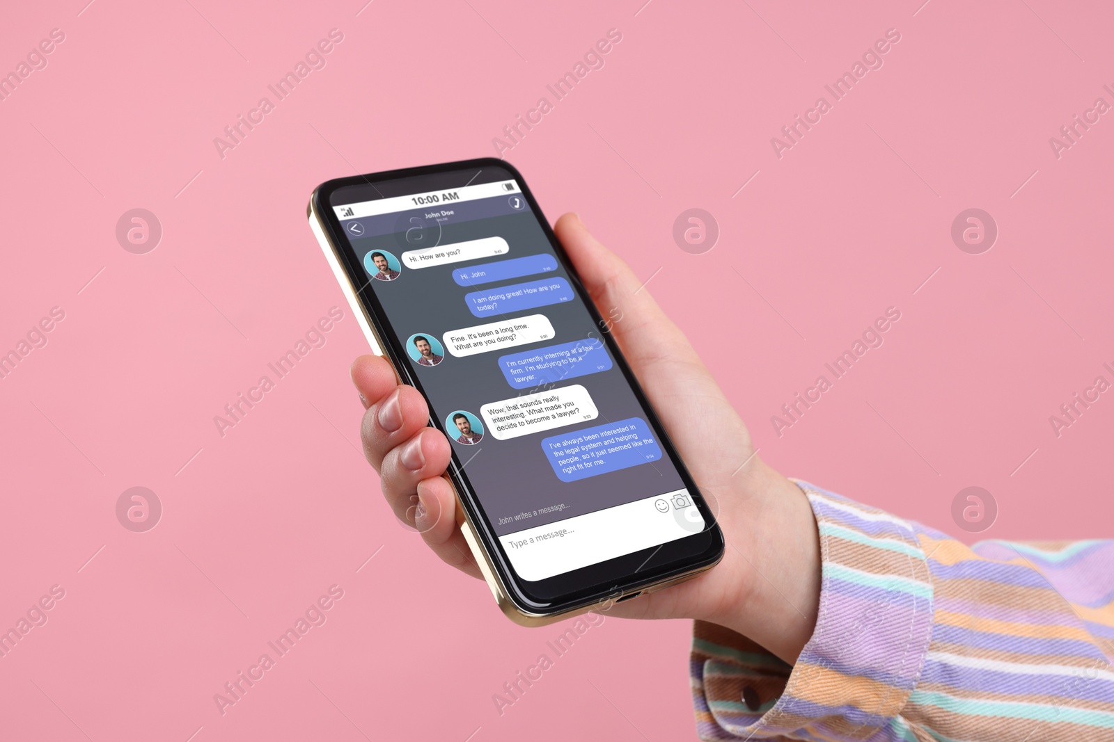 Image of Woman texting with friend using messaging application on smartphone against pink background, closeup