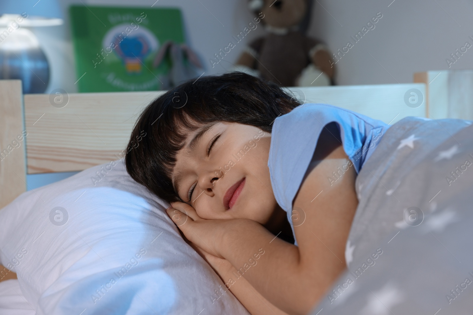 Photo of Cute little boy sleeping in bed at home