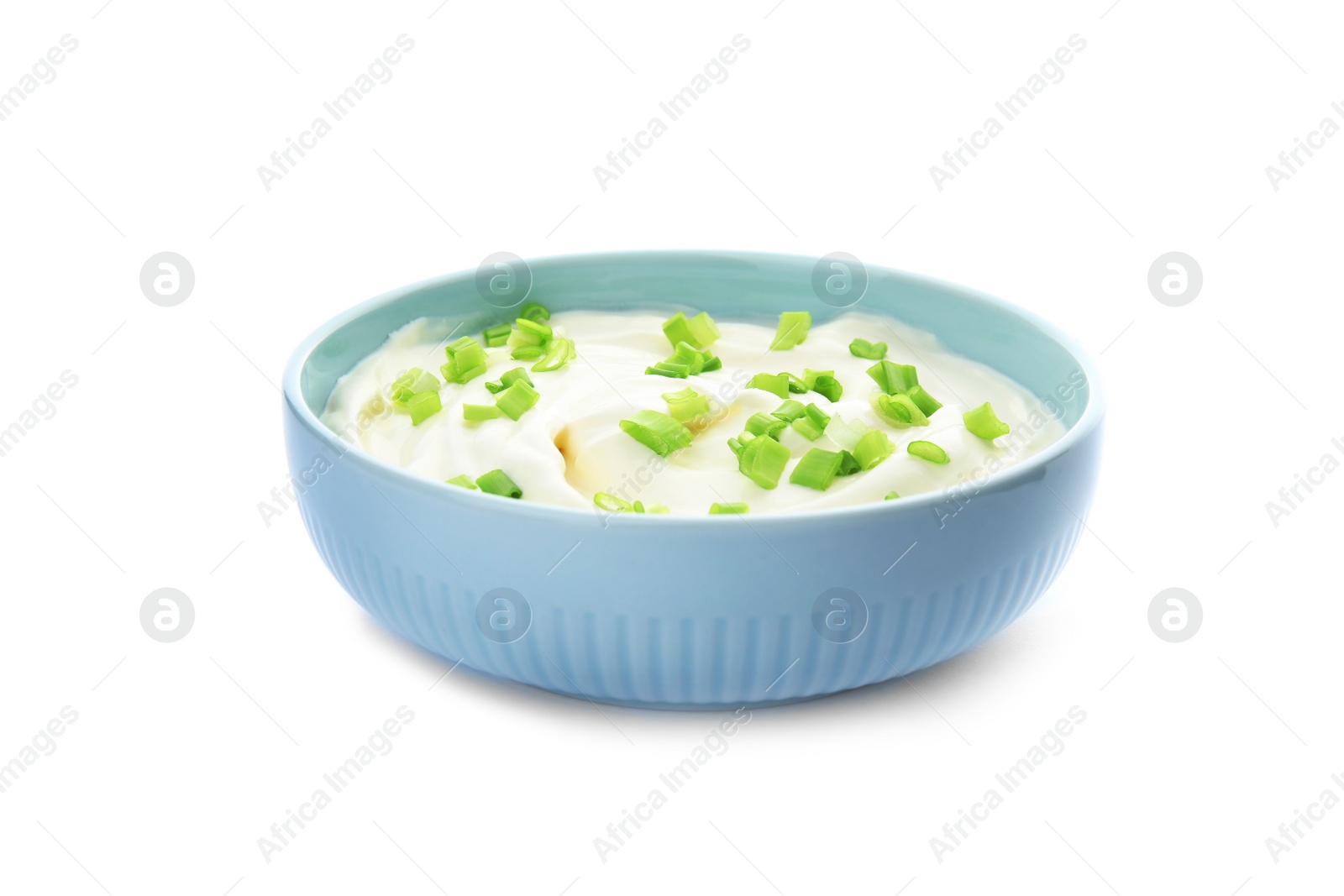 Photo of Bowl with sour cream and herbs on white background