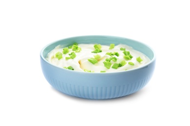 Bowl with sour cream and herbs on white background