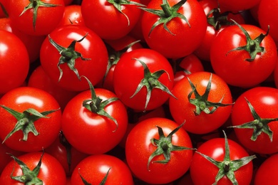 Photo of Delicious ripe cherry tomatoes as background, top view