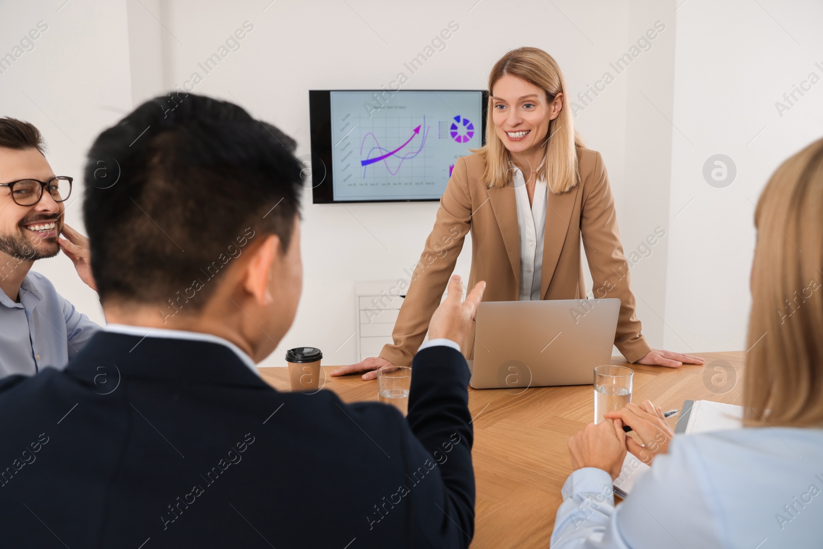 Photo of Businesswoman having meeting with her employees in office