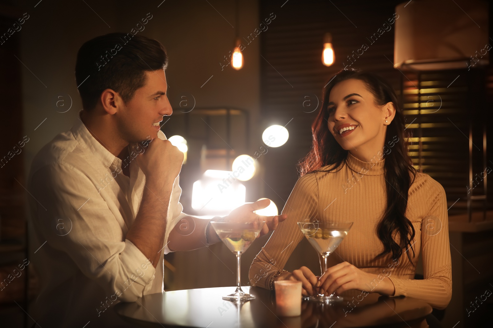 Photo of Man and woman flirting with each other in bar