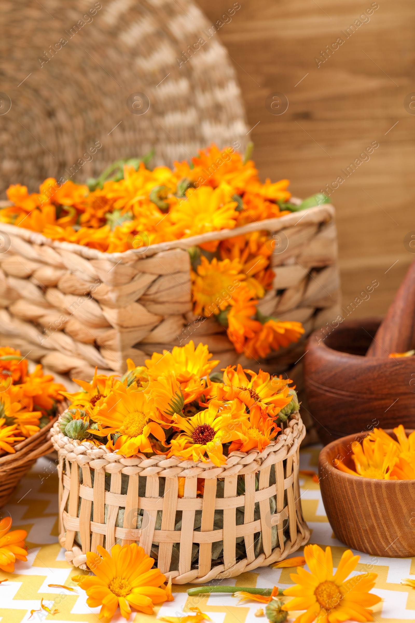 Photo of Many beautiful fresh calendula flowers on table