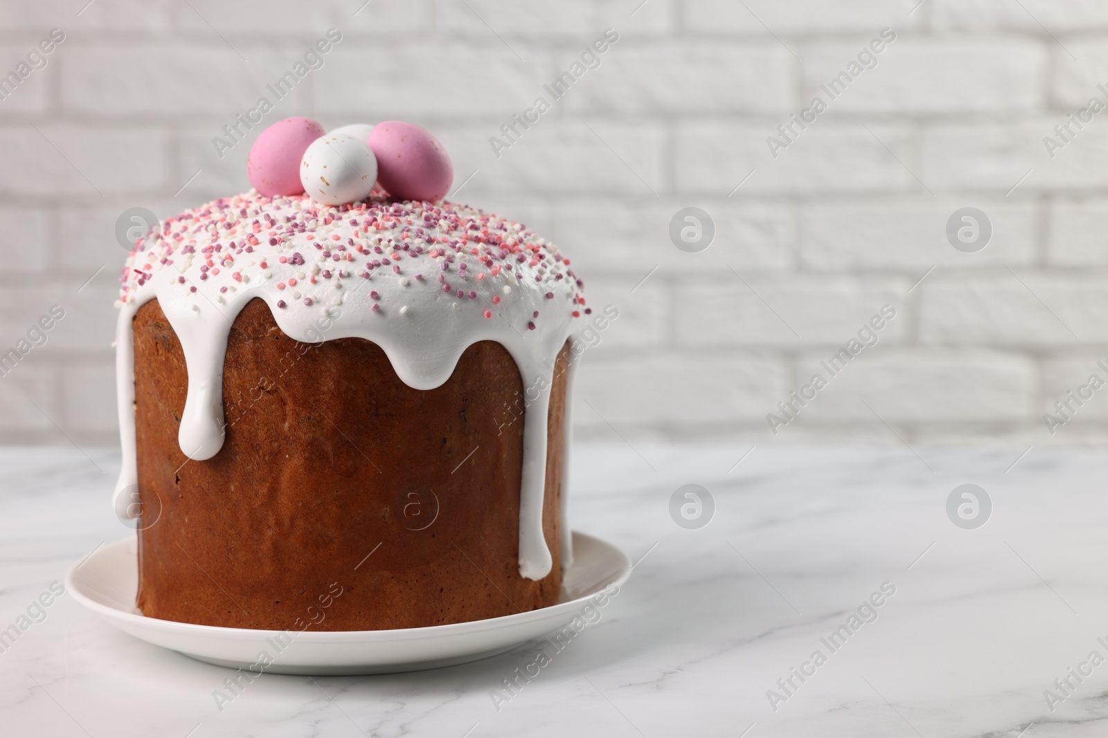 Photo of Tasty Easter cake on white marble table. Space for text
