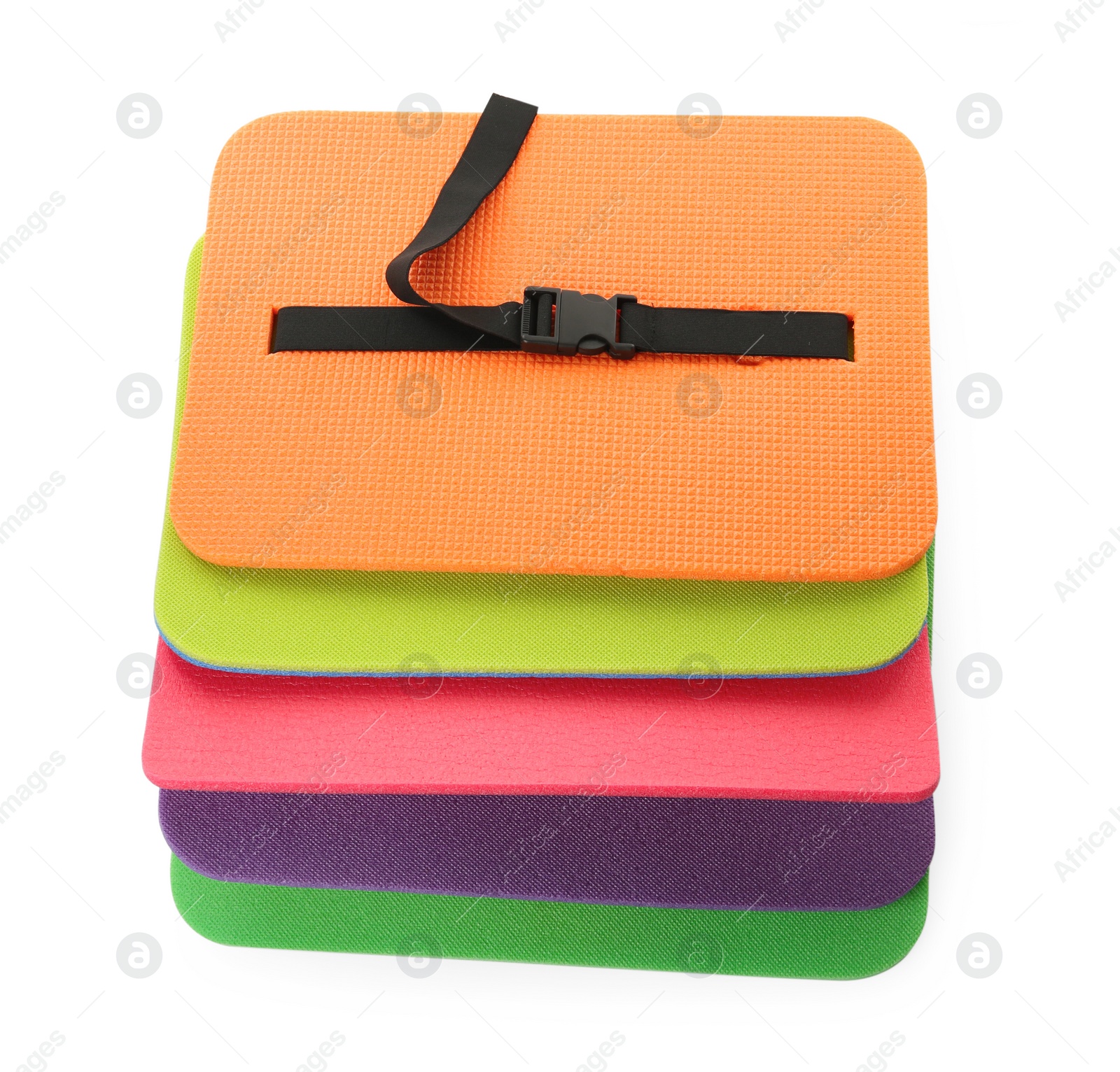Photo of Bright foam tourist seat mats isolated on white, top view