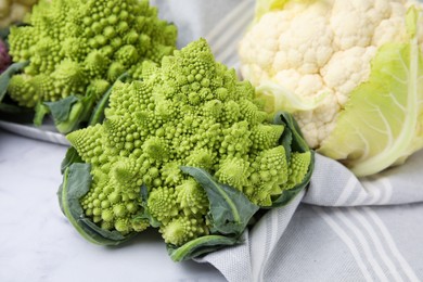 Fresh Romanesco broccoli and cauliflower on white table, closeup
