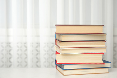 Photo of Collection of different books on table indoors. Space for text