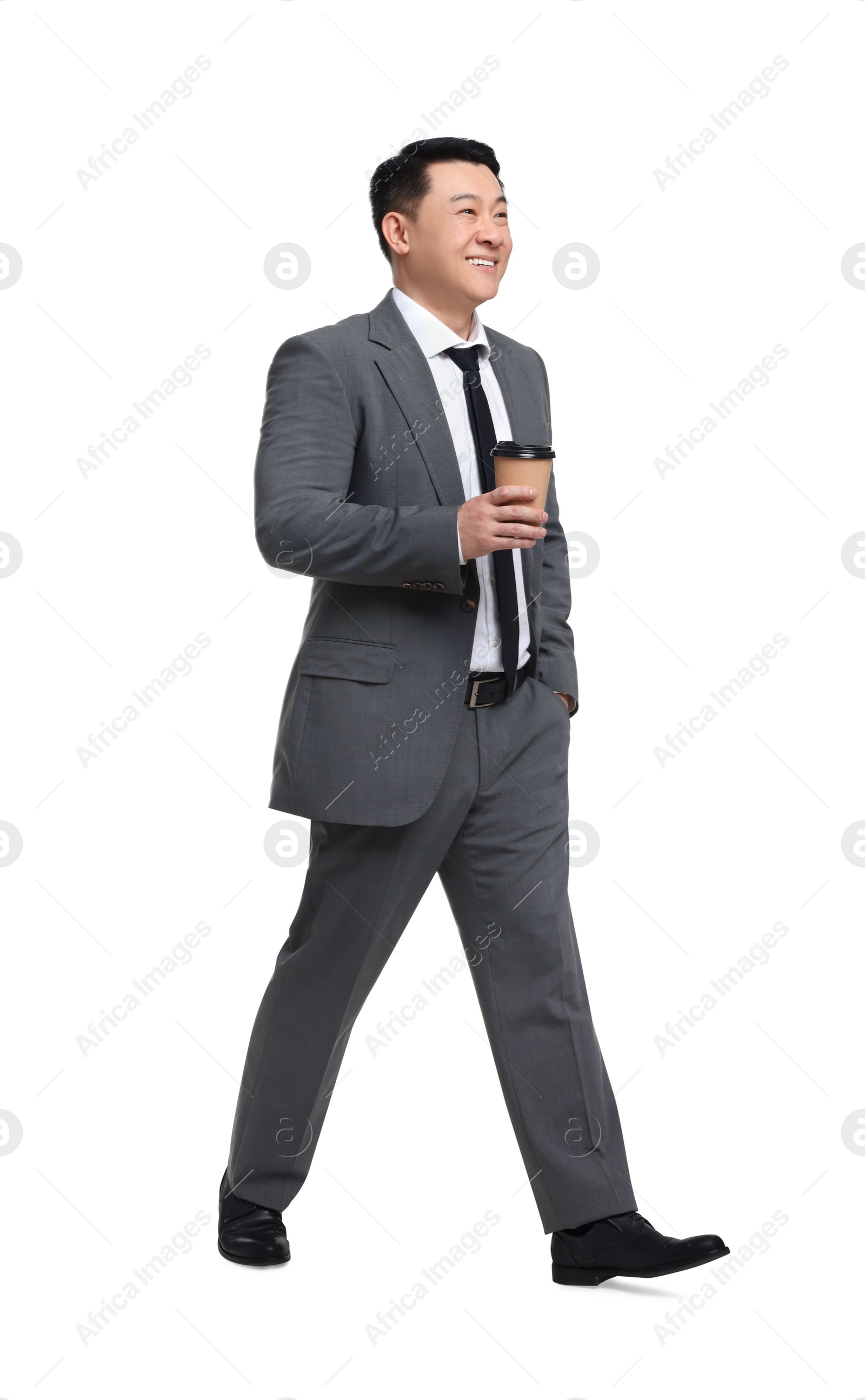 Photo of Businessman in suit with cup of drink walking on white background