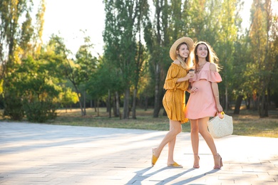 Photo of Beautiful young women in stylish dresses outdoors