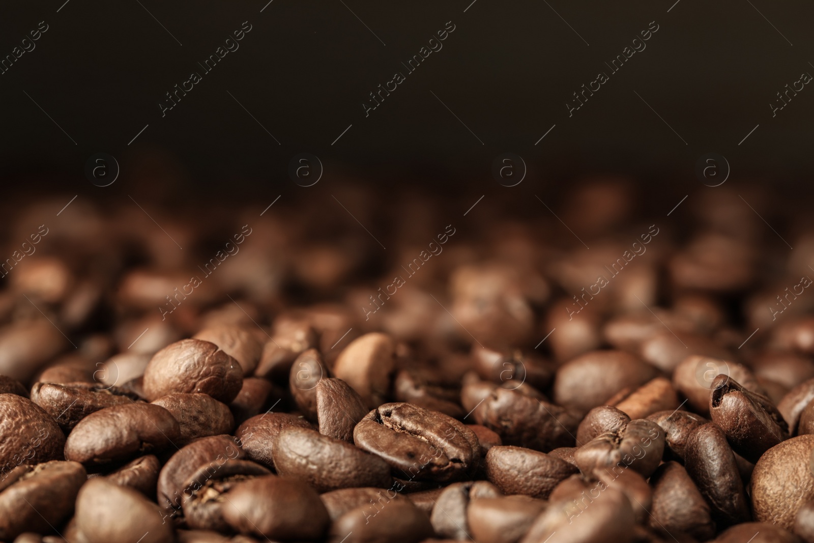 Photo of Heap of aromatic roasted coffee beans, closeup