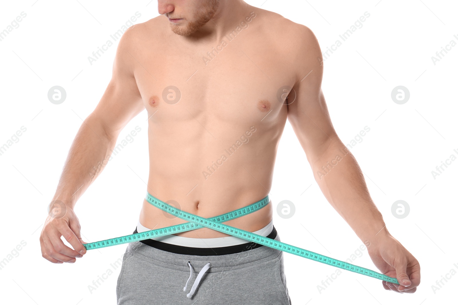 Photo of Young man with measuring tape showing his slim body on white background, closeup