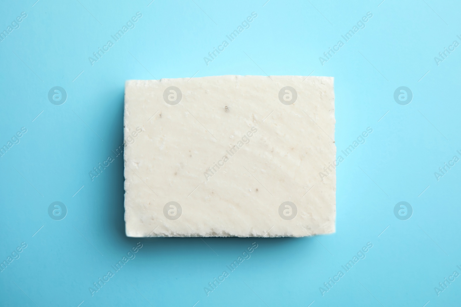 Photo of Hand made soap bar on color background, top view