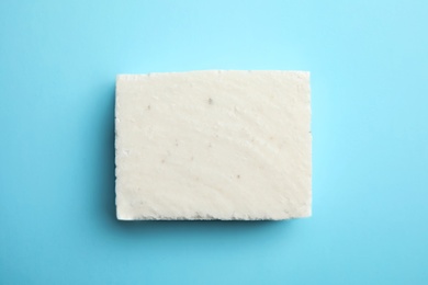 Photo of Hand made soap bar on color background, top view