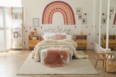 Photo of Stylish child's room interior with comfortable bed