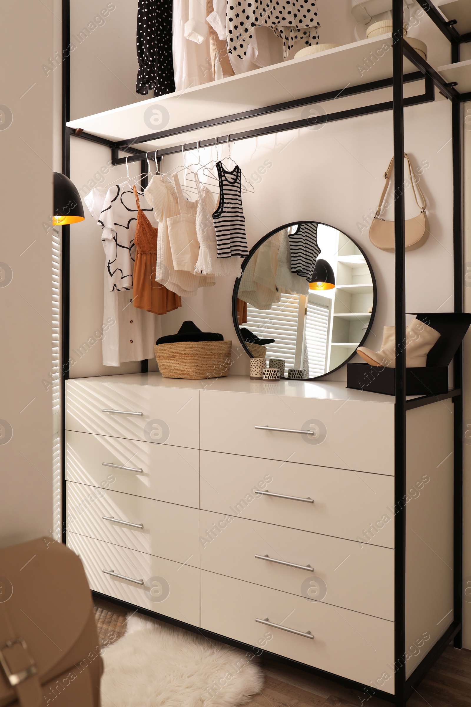 Photo of Closet interior with storage rack for clothes and accessories