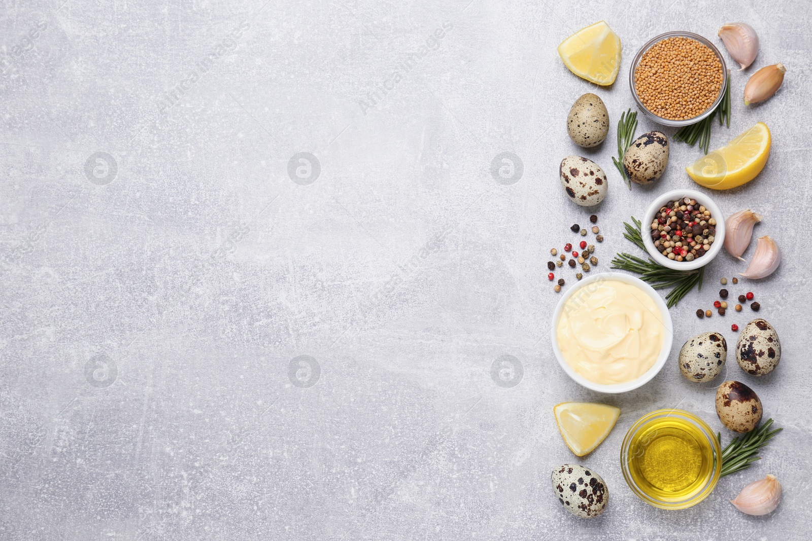 Photo of Delicious homemade mayonnaise, spices and ingredients on grey table, flat lay. Space for text