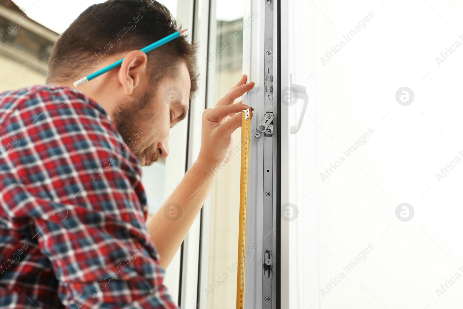 Photo of Man installing new modern window in house