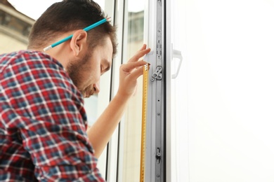 Man installing new modern window in house