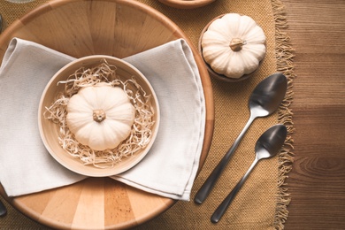 Photo of Autumn table setting with pumpkins and decor on wooden background, flat lay