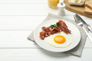 Photo of Delicious breakfast with sunny side up egg served on white wooden table. Space for text