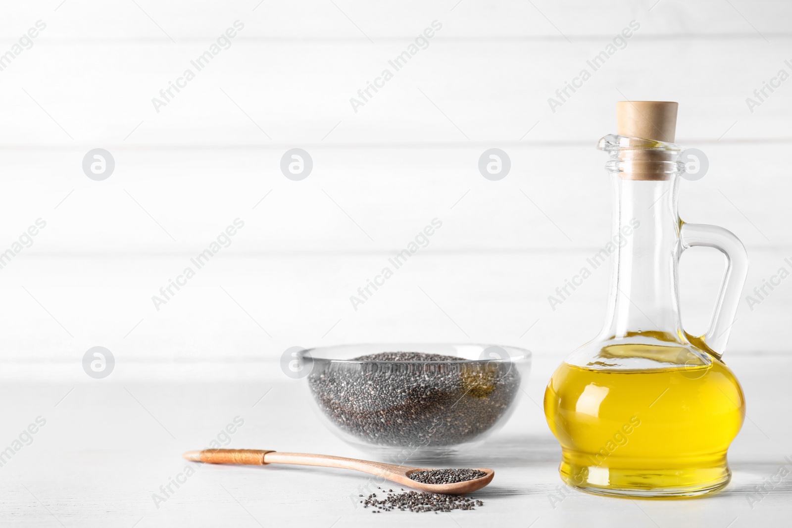 Photo of Composition with chia oil and seeds on table. Space for text