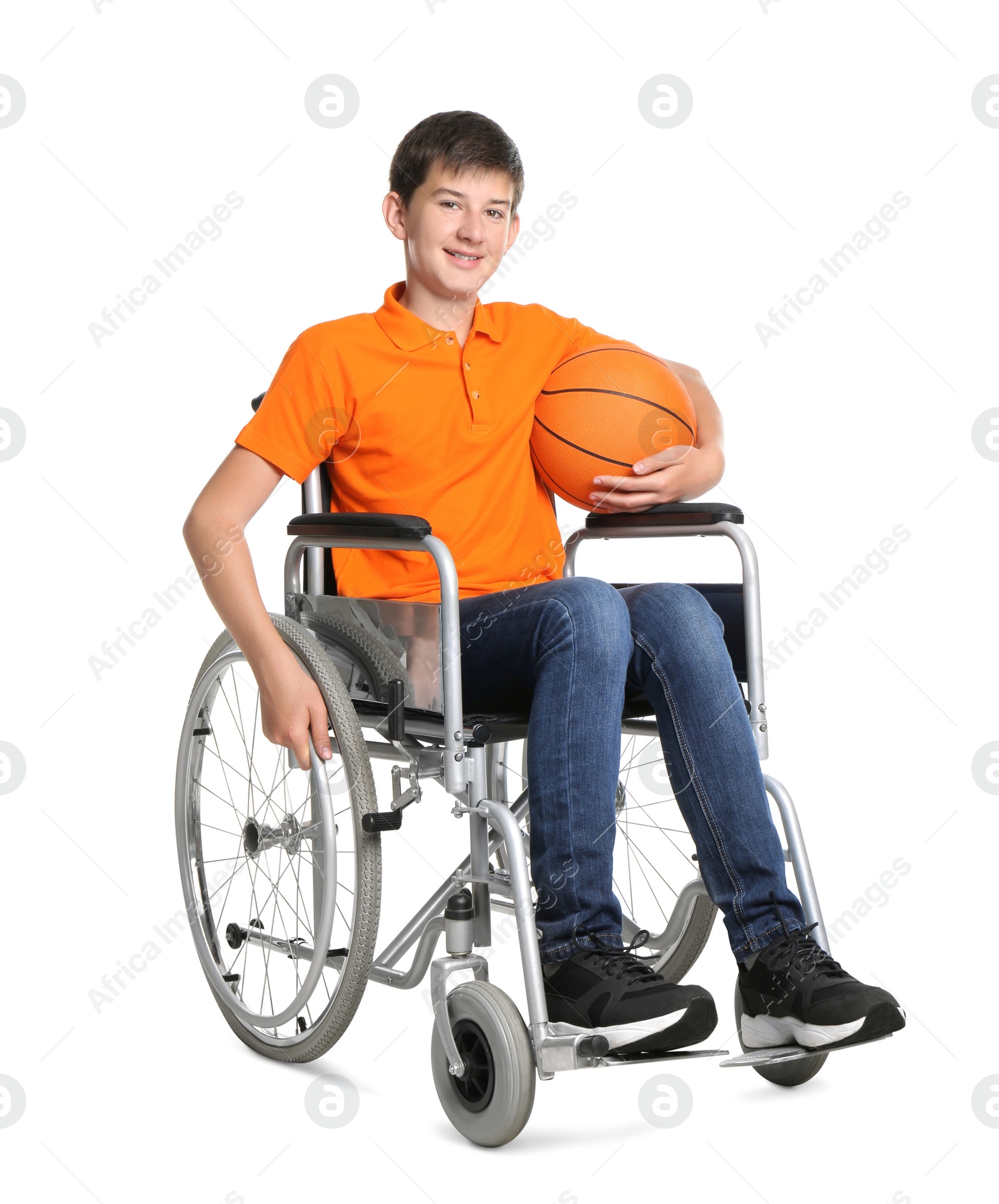 Photo of Disabled teenage boy in wheelchair with basketball ball on white background