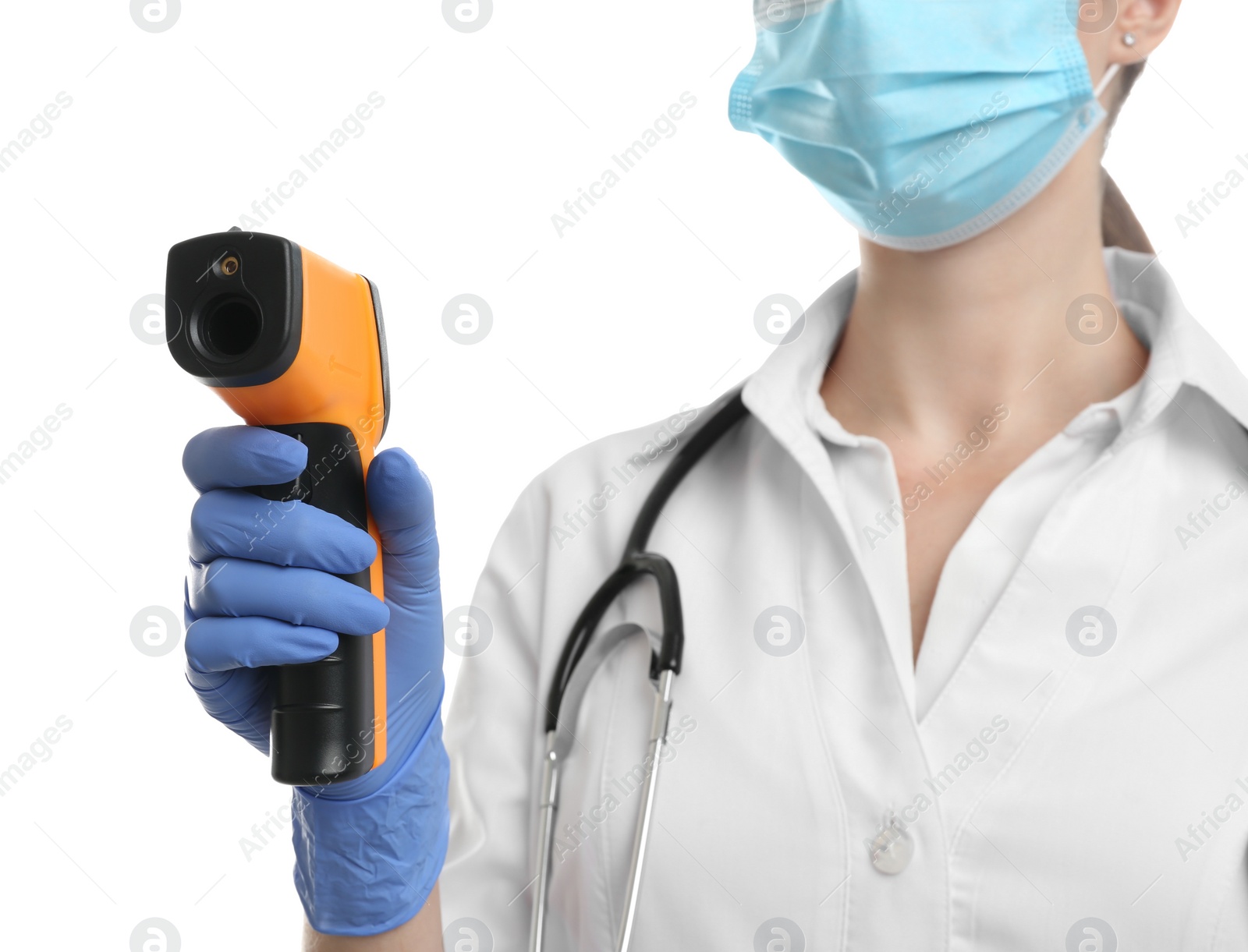 Photo of Doctor in latex gloves holding non contact infrared thermometer on white background, closeup. Measuring temperature