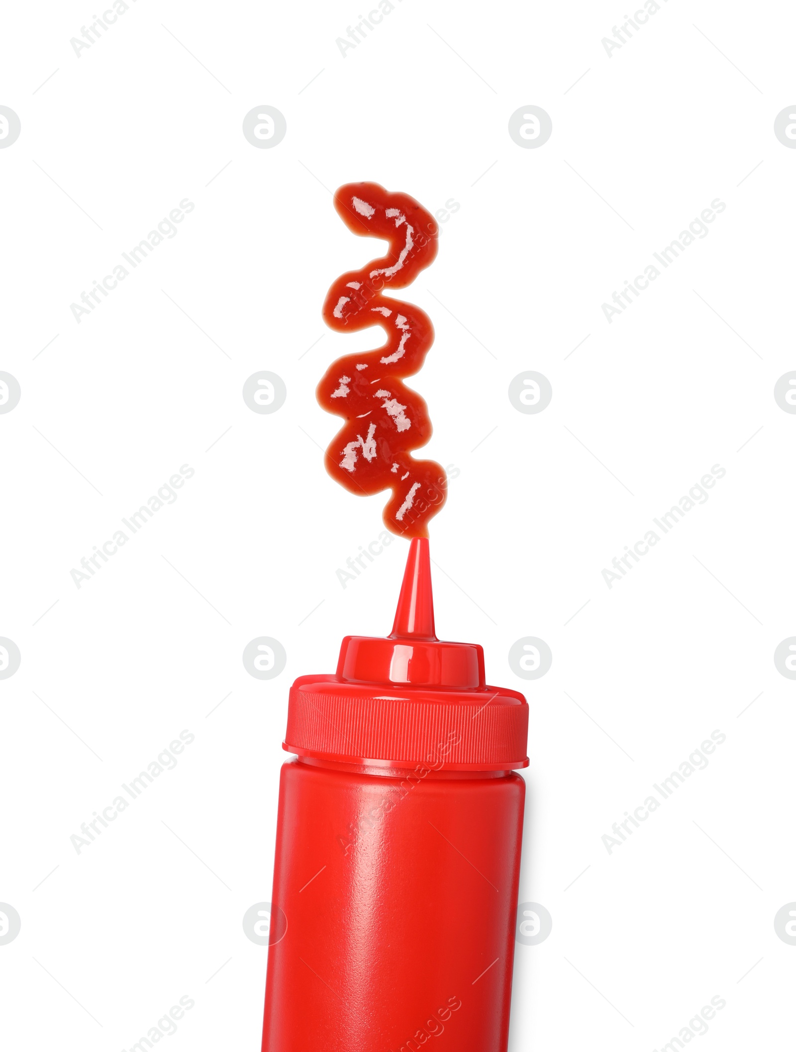 Photo of Squeezed ketchup from red bottle isolated on white, top view