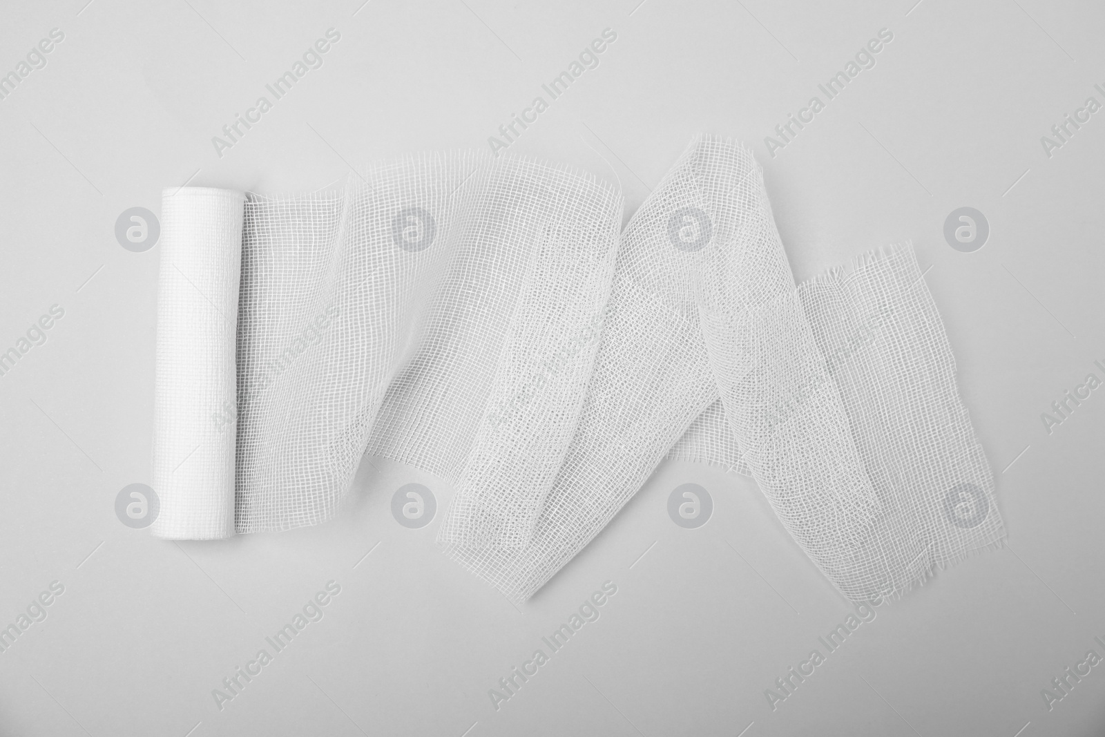 Photo of Medical bandage on white background, top view