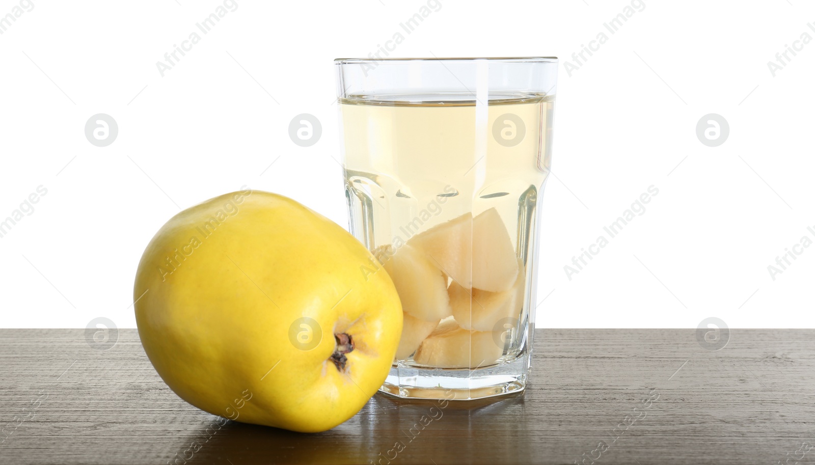 Photo of Delicious quince drink and fresh fruit on wooden table against white background