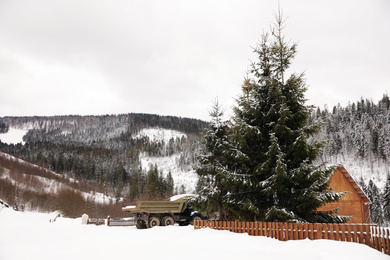 Photo of Beautiful landscape with cottage on snowy winter day