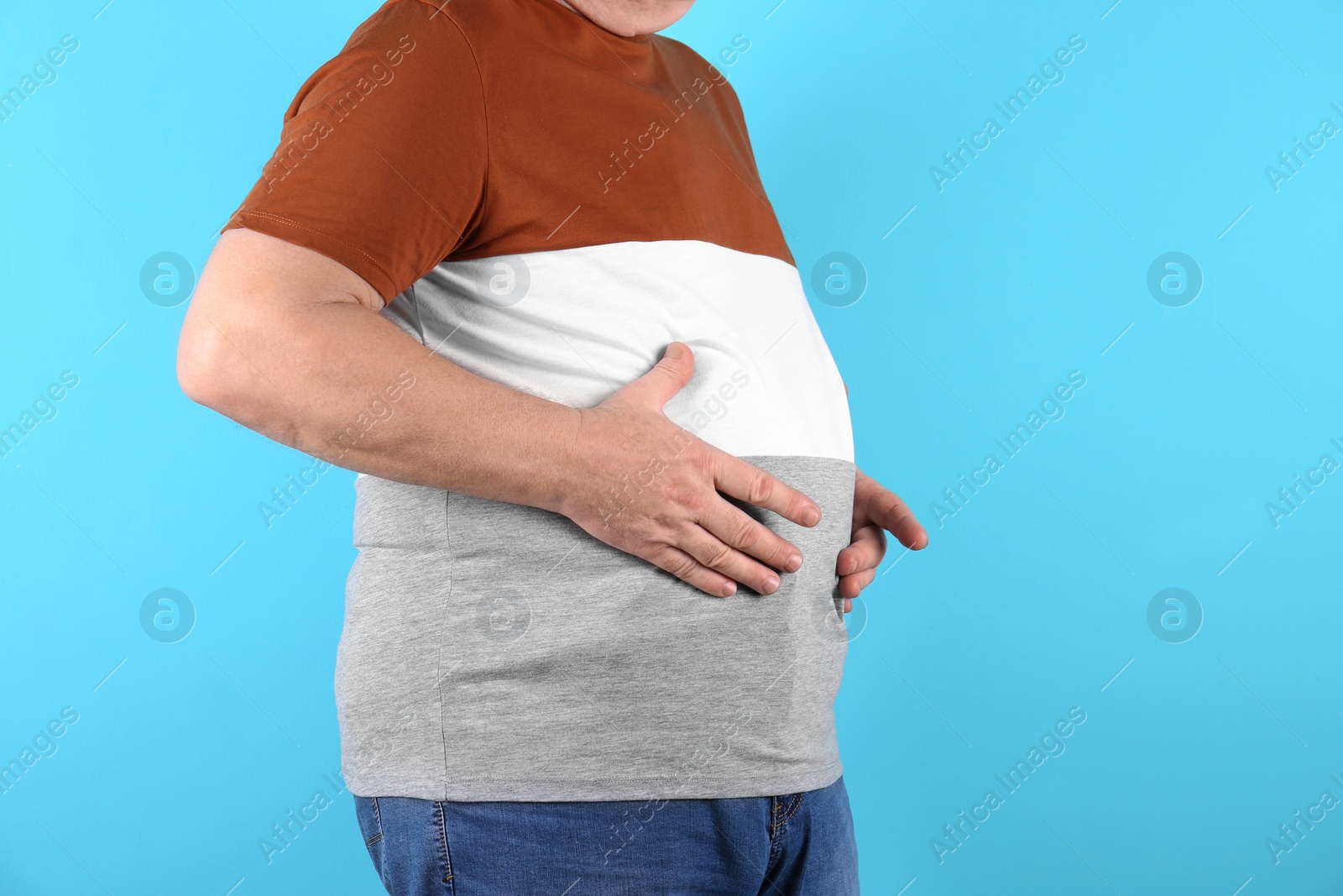 Photo of Fat senior man on color background, closeup. Weight loss