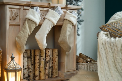 Fireplace with Christmas stockings in festive room interior