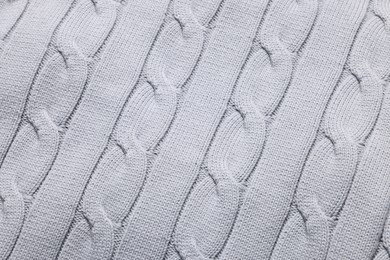 Texture of light grey knitted fabric as background, top view