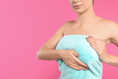 Woman checking her breast on color background, closeup. Space for text