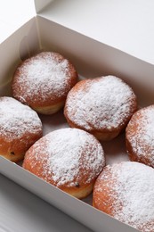 Photo of Delicious sweet buns in box on table, closeup