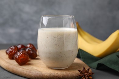 Photo of Glass of delicious date smoothie, dried fruits and anise on table, closeup