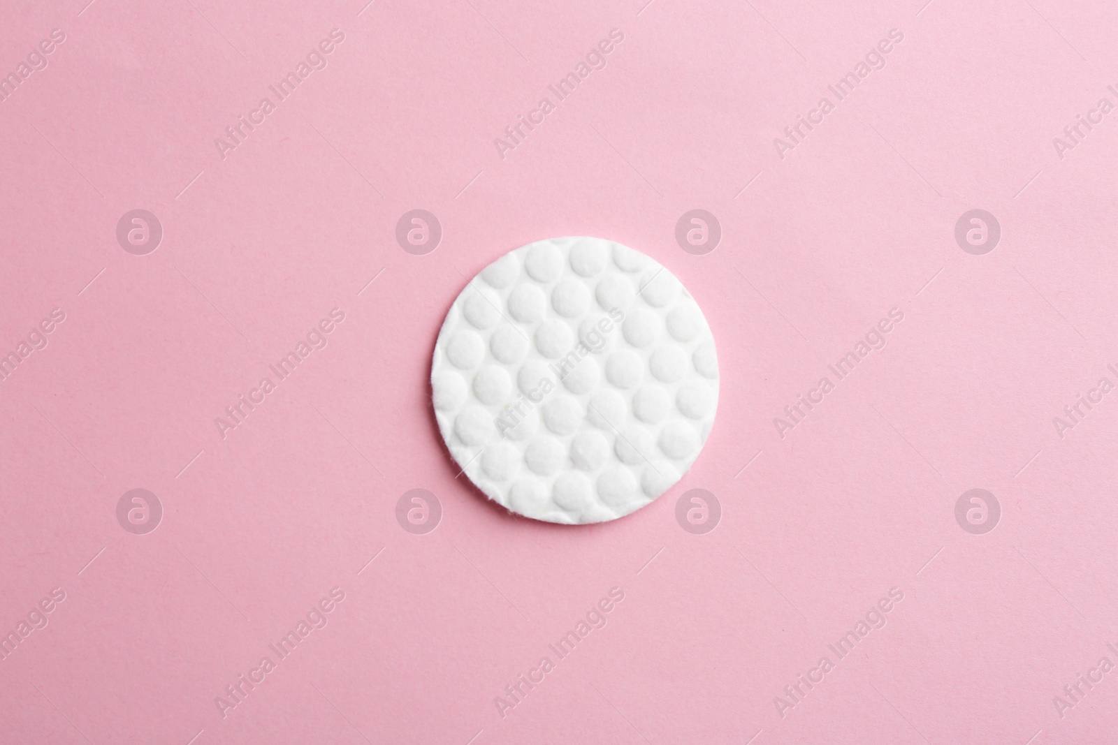 Photo of Cotton pad on color background, top view