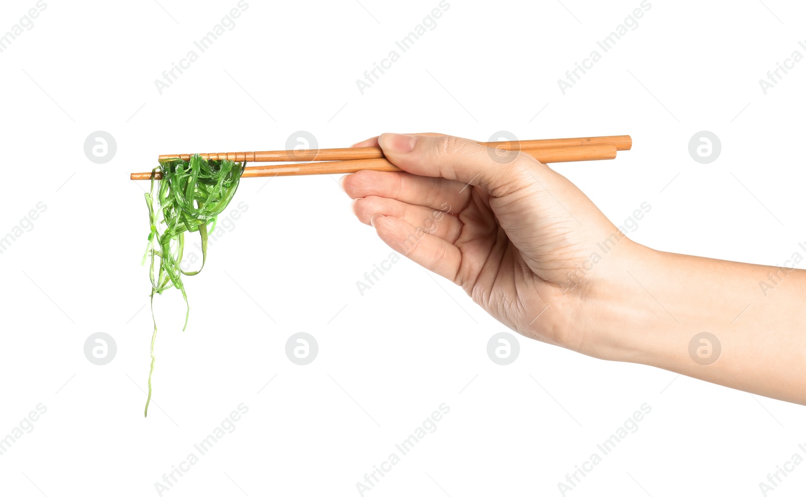 Photo of Woman holding chopsticks with Japanese seaweed salad isolated on white, closeup