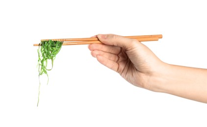 Photo of Woman holding chopsticks with Japanese seaweed salad isolated on white, closeup
