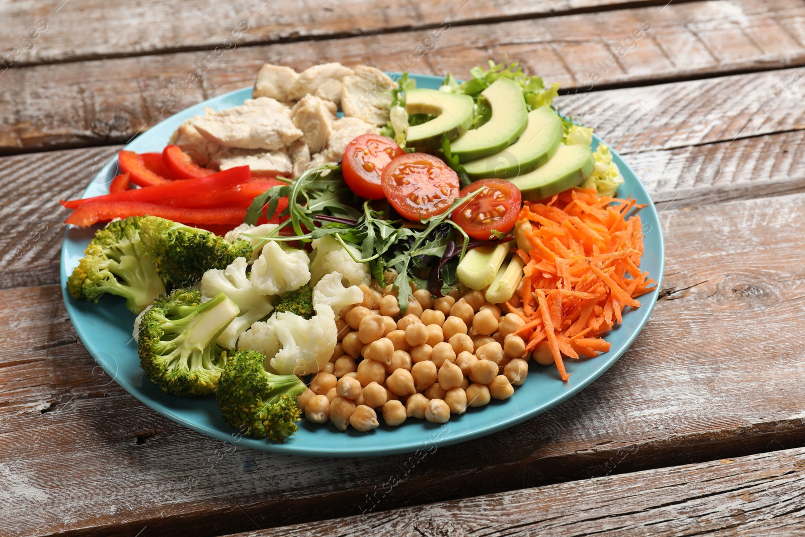 Photo of Balanced diet and healthy foods. Plate with different delicious products on wooden table