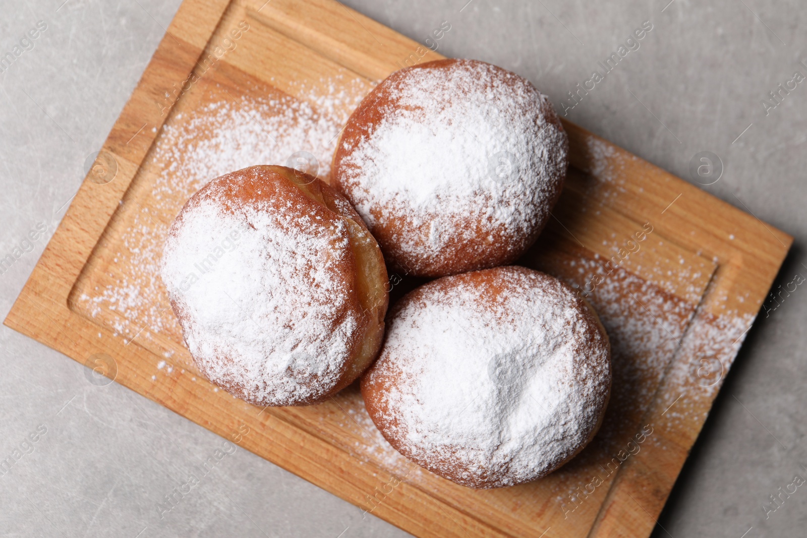 Photo of Delicious sweet buns on gray table, top view