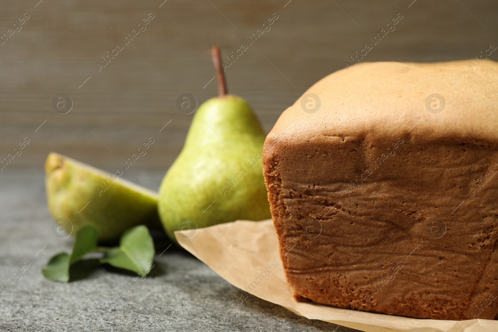 Photo of Tasty bread and pears on grey table, closeup. Homemade cake